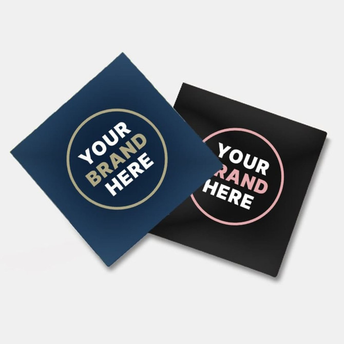 Two glossy paper stickers, one navy blue and one black, each featuring a circular design with a logo.