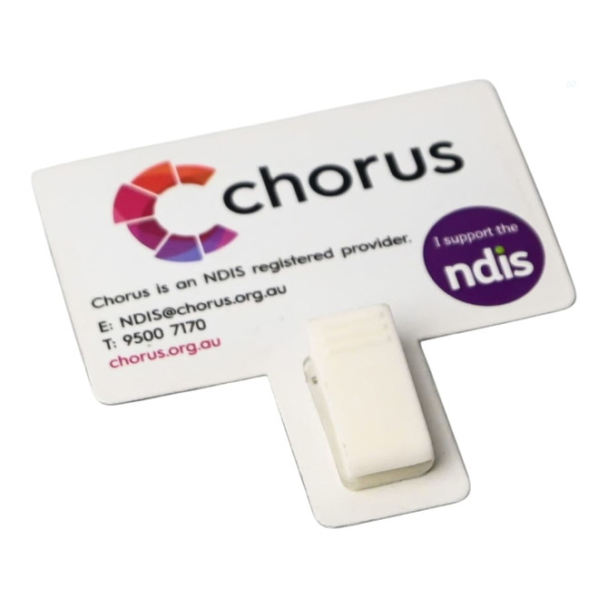 A white T-magnet with a clip, featuring a logo and text on a rectangular card.