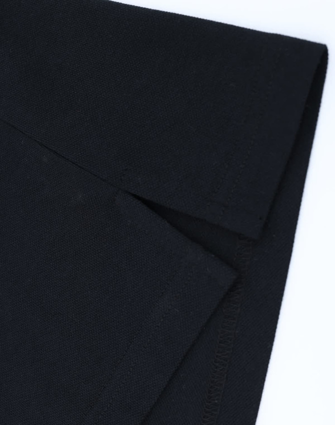 A black cotton/poly pique polo shirt showcasing the folded collar and sleeve detail. It has a logo on the fabric.