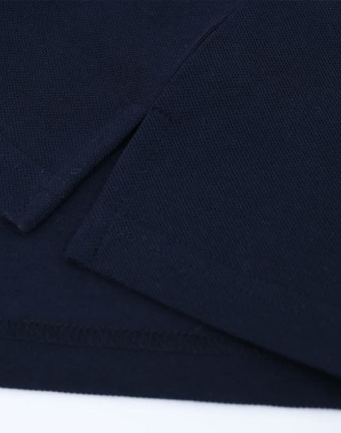 A navy blue cotton/poly pique polo with short sleeves and a subtle logo on the fabric.