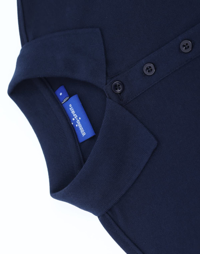 A navy blue polo shirt with a classic collar, featuring buttons and a tag inside.