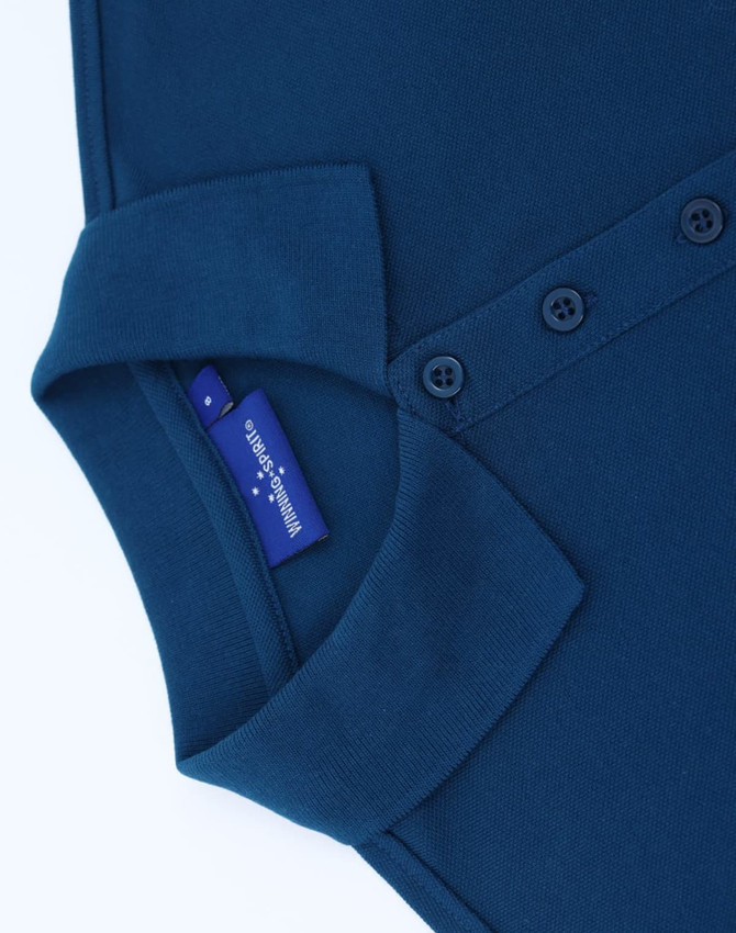 A navy blue ladies' classic cotton/poly pique short sleeve polo with a collar and button detailing. It has a logo tag.