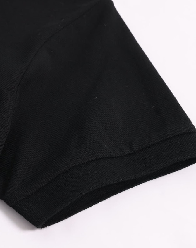 A black ultrafine cotton pique polo shirt with a smooth finish and a logo on the sleeve.