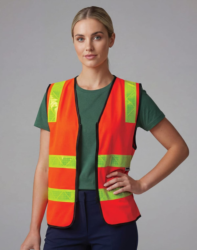 A hi-visibility safety vest in bright orange with reflective yellow stripes worn by a model.