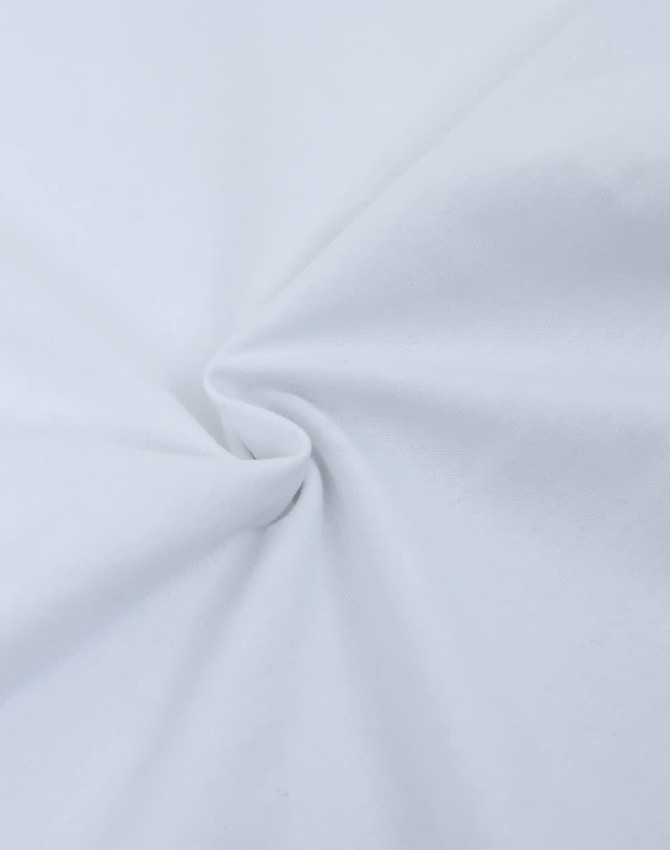 A close-up of white fabric, showcasing its heavy cotton texture and smooth surface. The fabric is gathered in a swirl.