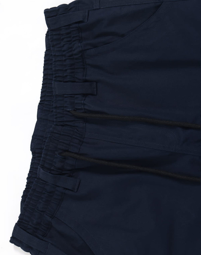 Navy cotton stretch drill cuffed work pants with elastic waistband and multiple pockets, featuring a logo.