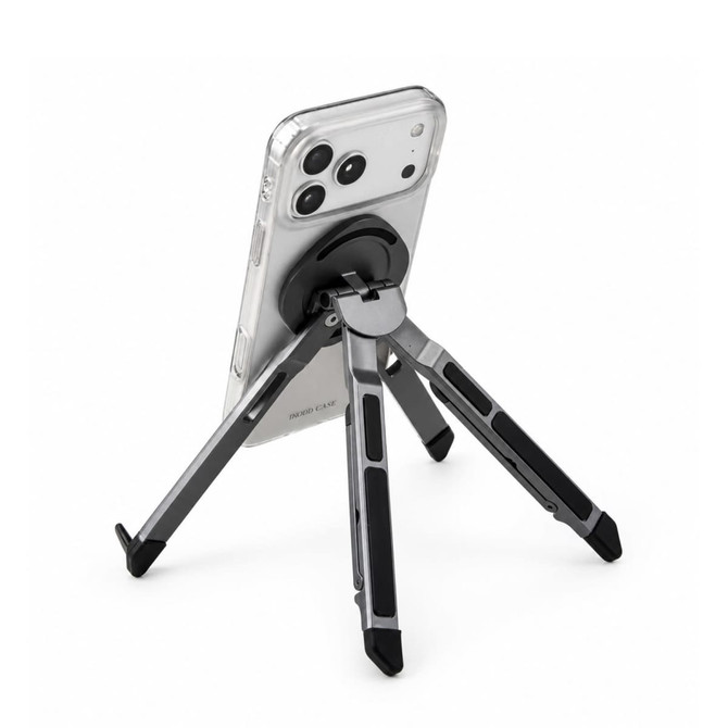 A silver and black Spider Device Stand holding a smartphone in a clear case, displaying its adjustable legs.