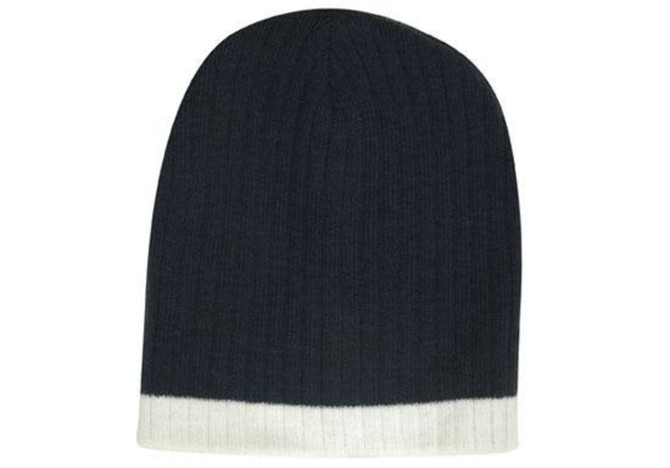 A two-tone cable knit beanie in navy blue and white, featuring a ribbed design and a subtle logo.
