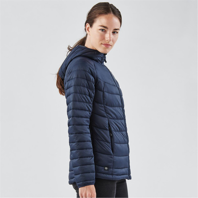 A navy women's thermal jacket featuring a hood and quilted design, with a branded logo on the side.
