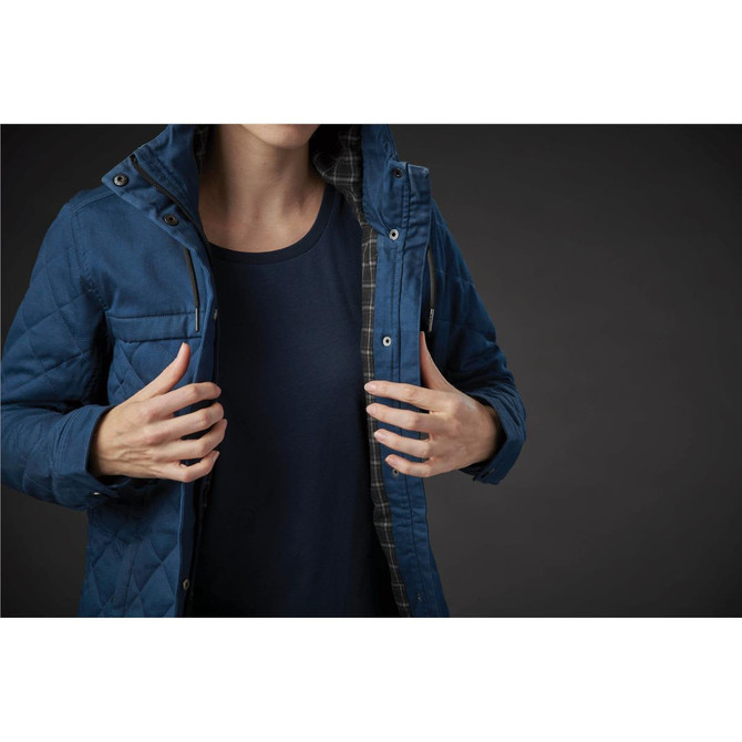 A blue quilted jacket featuring a hood and checkered lining, shown on a person with a navy shirt.