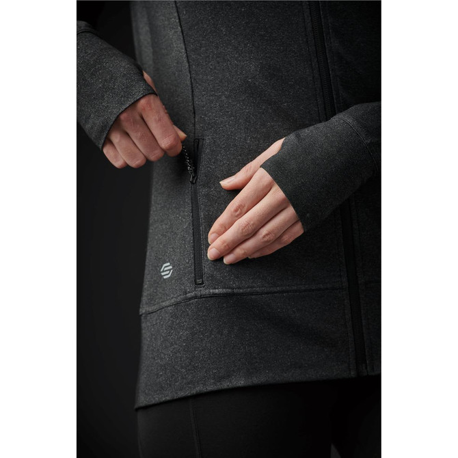 A close-up of a women's black jacket featuring a zippered pocket and a logo on the side.