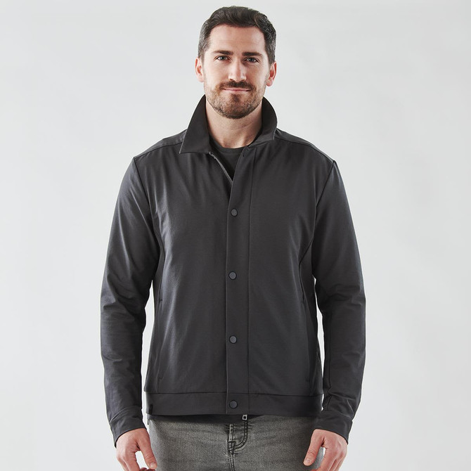 A black men's jacket with a collared design, featuring buttons and a logo. The model stands against a plain background.