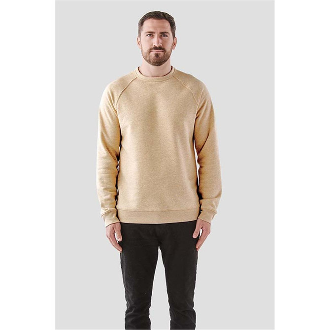 A man wearing a cream-coloured fleece crew neck sweater with a logo on the front and long sleeves.