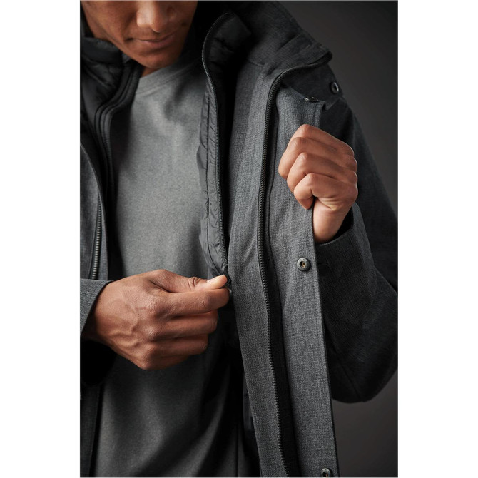 A man holding a grey Men's Montauk System Jacket, showcasing the interior lining and zippered opening.