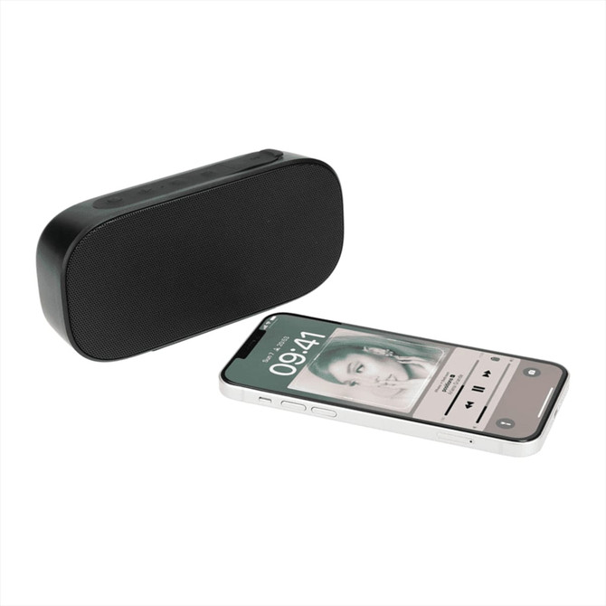 A black Bluetooth speaker next to a smartphone displaying music playback, featuring a logo on the speaker.