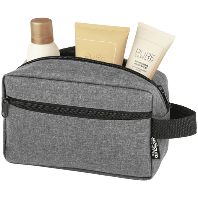 A grey toiletry bag with a zip, containing two tubes of lotion and a bottle of shampoo inside.