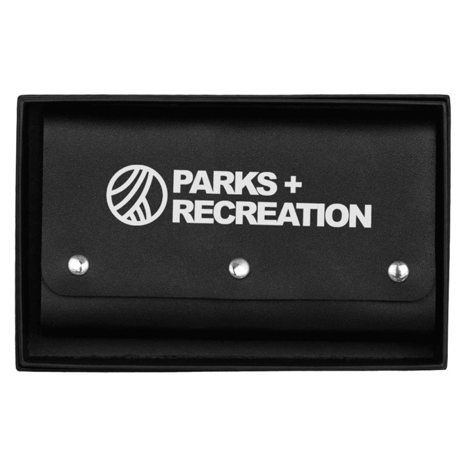 A black leather travel card set with a branded cover, featuring a snap closure. Packed in a matching box.