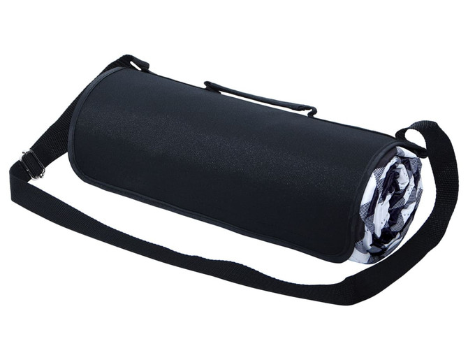 A large picnic rug rolled up in a black carry bag with a shoulder strap and a patterned inner design.