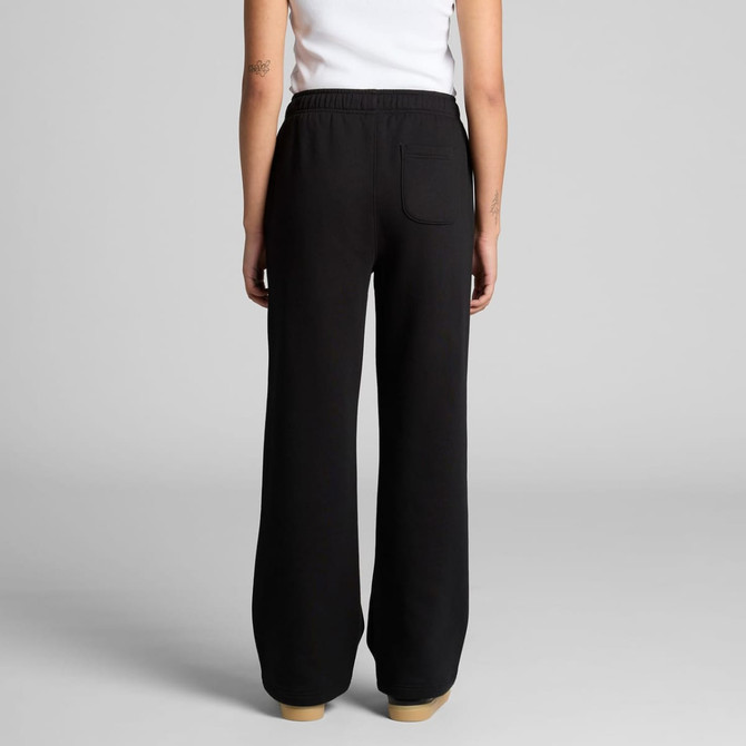 Cuffless black track pants with a relaxed fit and a back pocket, showcased on a model from the rear.
