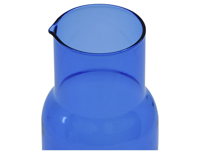 A blue glass carafe with a spout, designed for serving beverages. It has a sleek, modern shape and a shiny finish.
