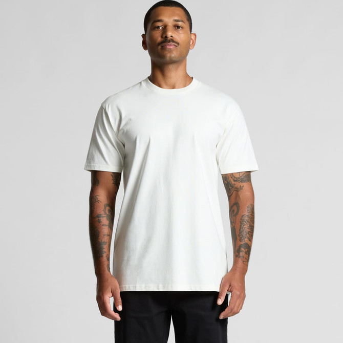 A man wearing a plain white organic t-shirt with short sleeves. The shirt has a logo on it.