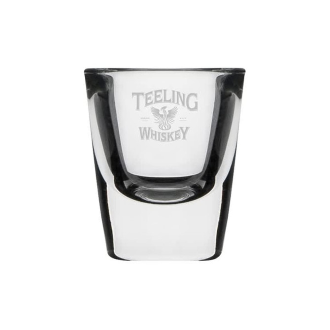 A clear glass shot glass with a logo, featuring a classic design and a smooth finish.