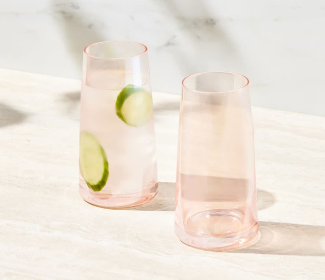 A set of two highball glasses in soft pink, featuring a modern design and minimalistic style.