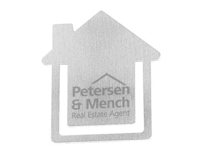 A metallic business card holder shaped like a house with a logo and branding on the surface.