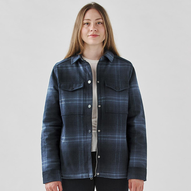 A plaid jacket in navy and blue tones with a Sherpa lining and snap buttons. Features two chest pockets and a logo.