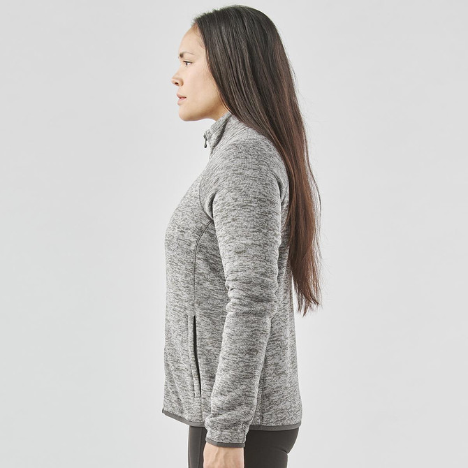 A women's full zip fleece jacket in grey, featuring a high collar and side pockets, with a logo.