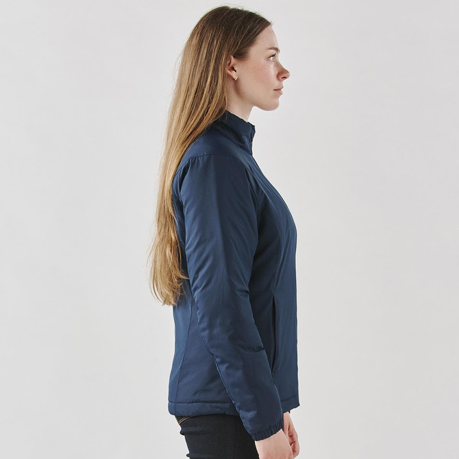 A side view of a women's navy thermal jacket, featuring a collar and zippered design. The model has long hair.