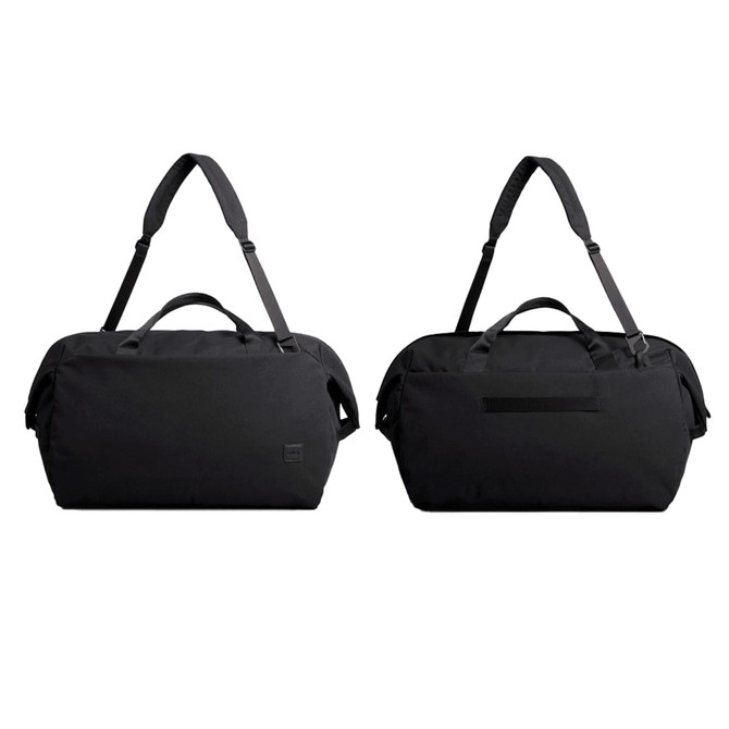 A black duffel bag with dual handles and an adjustable shoulder strap, featuring a logo on the side.