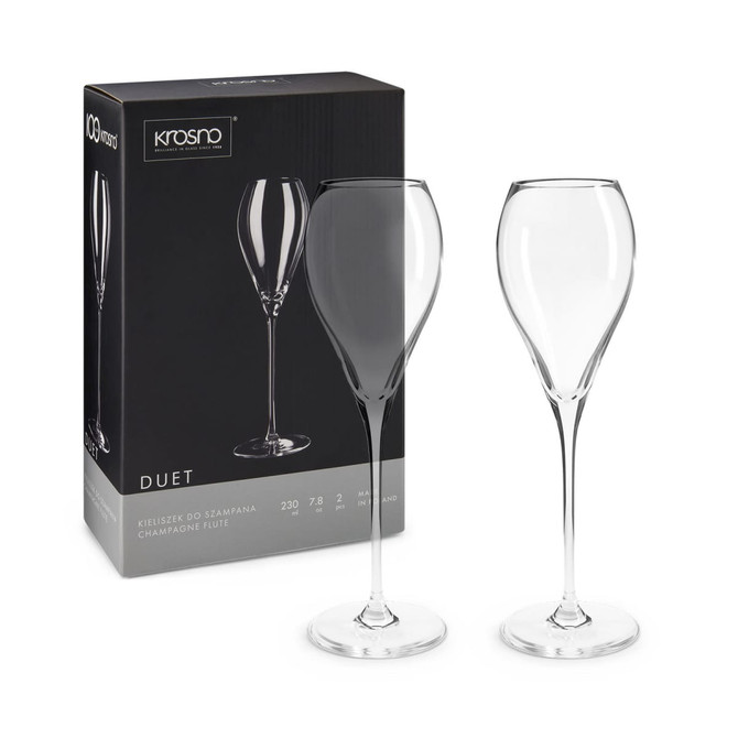 A set of two clear champagne flutes with a slender design, packaged in a stylish box featuring a logo.