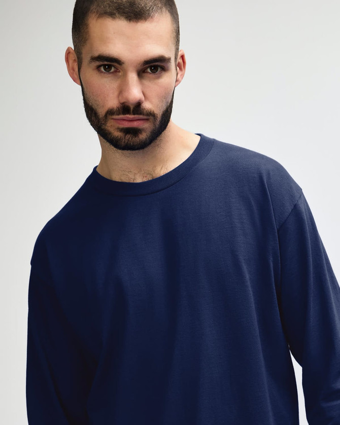 A navy long sleeve T-shirt designed for adults, displayed on a model with a neutral background.