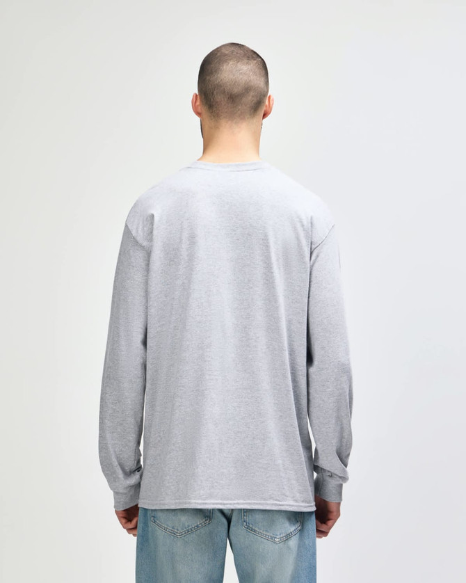 A woman wearing a grey Gildan Ultra Cotton adult long sleeve t-shirt, viewed from the back, paired with navy leggings.