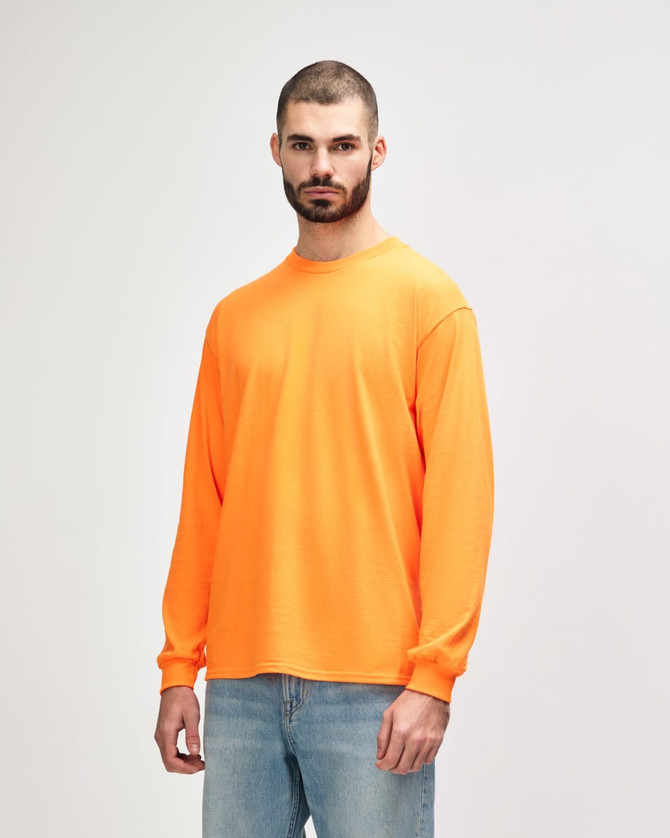 An orange long sleeve t-shirt displayed on a model, featuring a plain design and a logo.