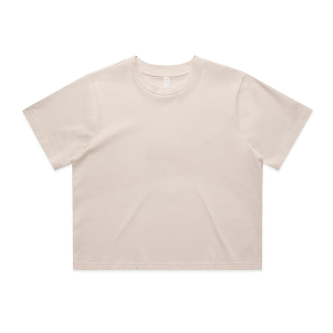 A cropped t-shirt in a light beige colour, featuring a simple design and short sleeves. It has a logo.