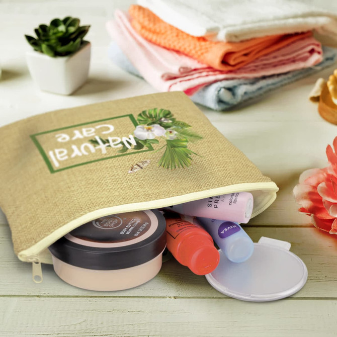 A natural-coloured cosmetic bag containing various skincare products and a compact. Features a logo on the front.