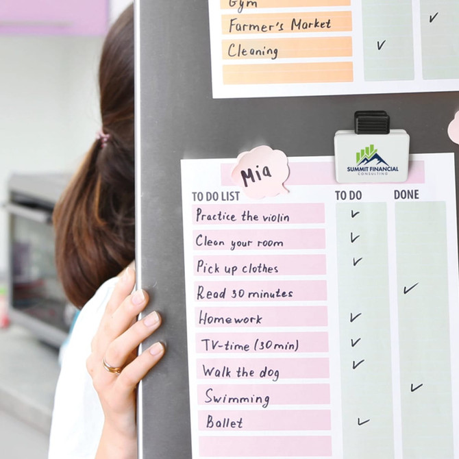 A magnetic clip in white and black, holding a colorful to-do list on a board, featuring a logo.