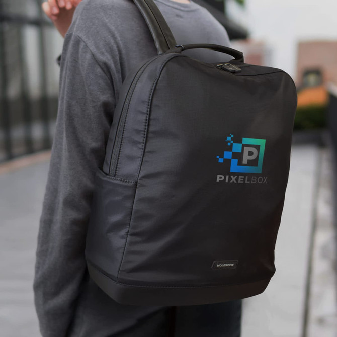 A black Moleskine Ripstop Backpack with a logo, worn on a person's back, featuring a sleek design and sturdy handle.