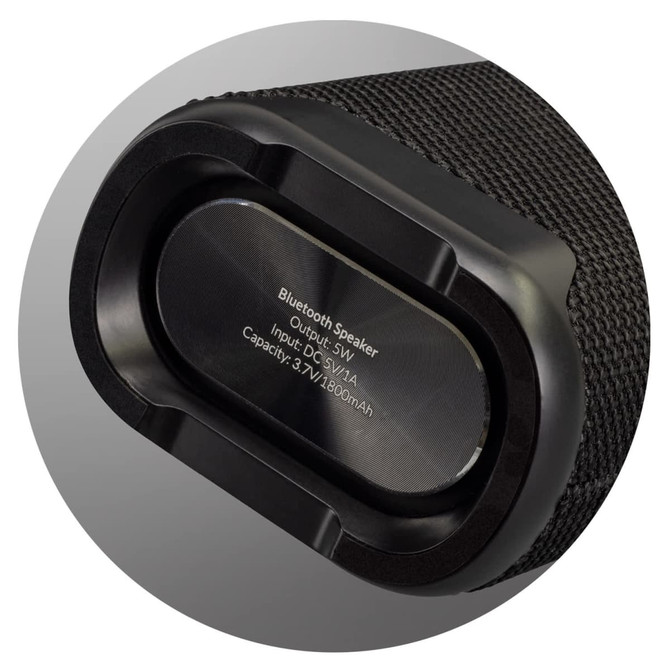 A black Bluetooth speaker with a textured exterior, featuring a silver output section and branding.