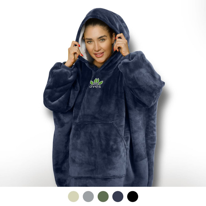 A woman wearing a navy blue hoodie blanket with a large hood and a front pocket, featuring a logo.