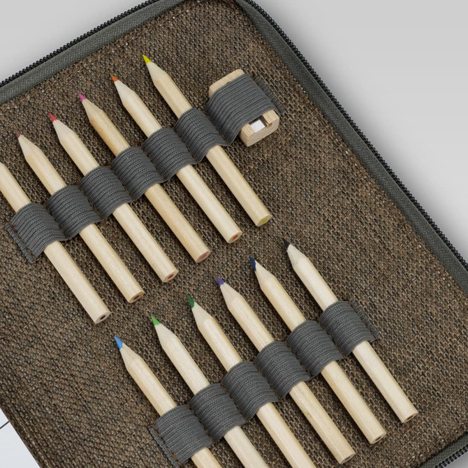 A portable drawing set featuring a rectangular case with several coloured pencils secured by grey straps.
