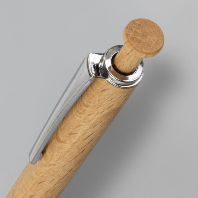 A close-up of a wooden pen with a silver clip and a wooden top. The pen features a natural wood finish.