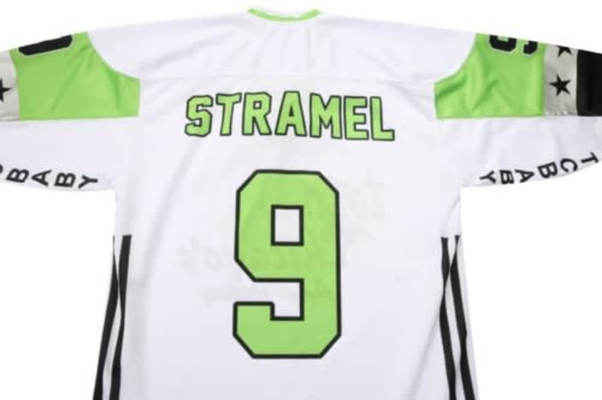 A white ice hockey racing suit featuring bright green accents and a large number 9 on the back, with a logo present.