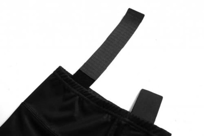 A black ice hockey racing suit showcasing a sleek design with a prominent fastening strap.