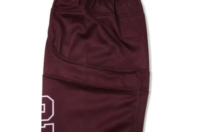 A pair of maroon ice hockey socks featuring a textured design and a logo.