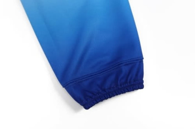 A pair of ice hockey socks in gradient shades of blue with an elasticised cuff. Features a logo.