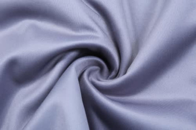 A smooth, light blue fabric with a subtle sheen, featuring a swirl pattern. Ideal for sports uniforms and jackets.