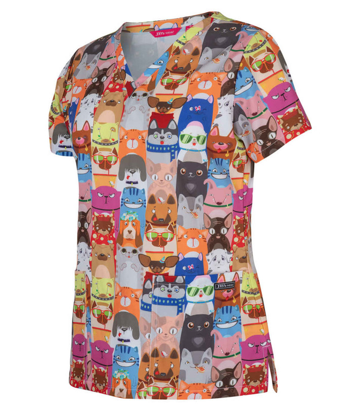 A colourful scrub top featuring a playful animal print in orange, blue, and red tones. It has a logo on it.